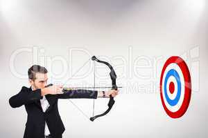 Composite image of elegant businessman shooting bow and arrow