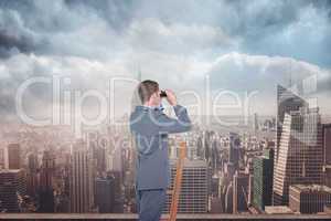 Composite image of businessman looking on a ladder