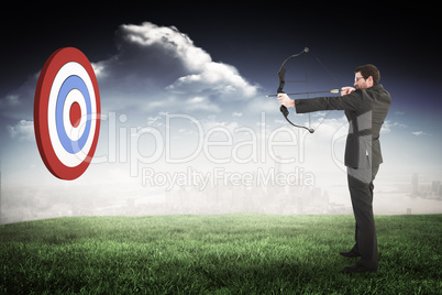 Composite image of businessman shooting a bow and arrow