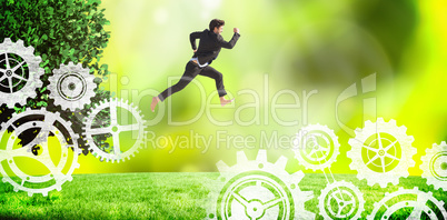 Composite image of businessman leaping