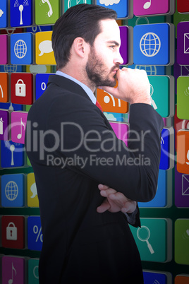 Composite image of thinking businessman standing with hand on ch Composite image of thinking businessman standing with hand on ch