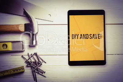 Diy and save! against tablet displaying blueprint