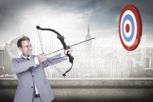 Composite image of businessman shooting arrow