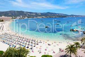 The tourists enjoiying their vacation on the beach, Mallorca, Sp