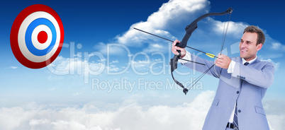 Composite image of businessman shooting arrow