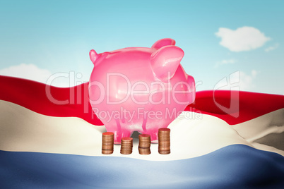 Composite image of coins and piggy bank