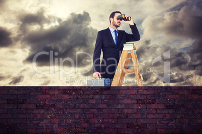 Composite image of businessman looking on a ladder