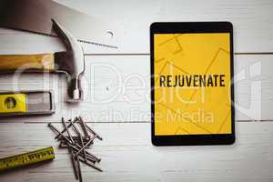 Rejuvenate  against digital tablet displaying blueprint
