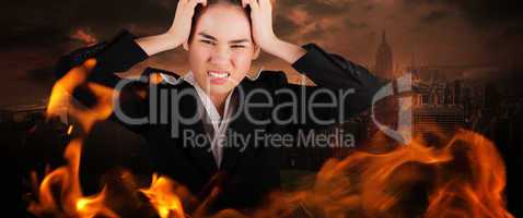 Composite image of stressed businesswoman with hands on her head