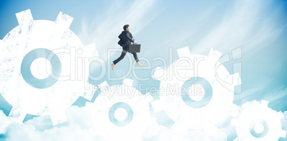 Composite image of businessman jumping