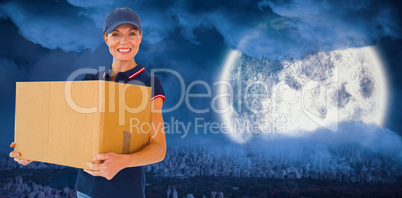 Composite image of happy delivery woman holding cardboard box