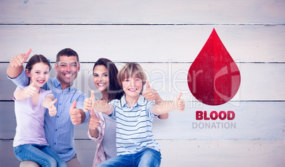 Composite image of happy family gesturing thumbs up