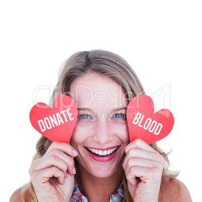 Composite image of woman holding heart cards