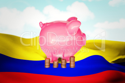 Composite image of coins and piggy bank