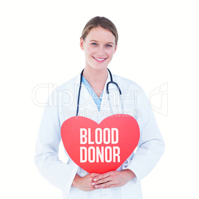 Composite image of doctor holding red heart card
