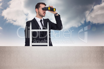 Composite image of businessman looking on a ladder