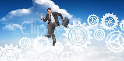 Composite image of happy businessman in a hurry