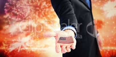 Composite image of businessman holding out his hands to the came