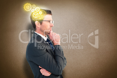 Composite image of frowning businessman thinking