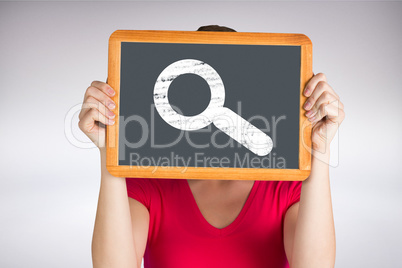 Composite image of woman holding chalkboard over face