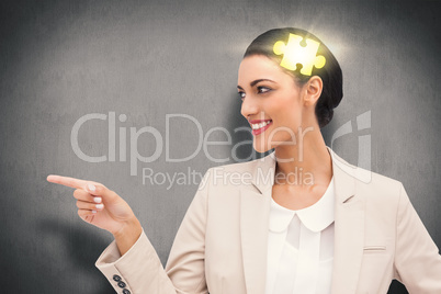 Composite image of smiling businesswoman pointing