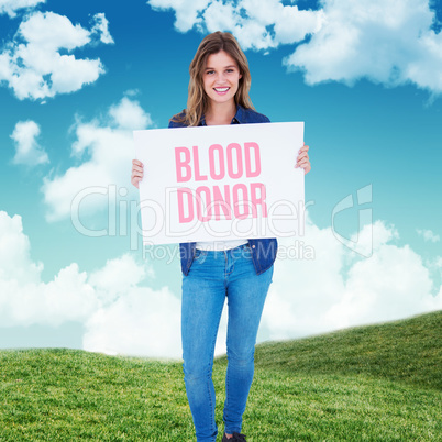 Composite image of woman holding poster