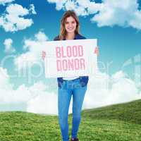 Composite image of woman holding poster