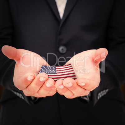 Composite image of businessman holding his hands out