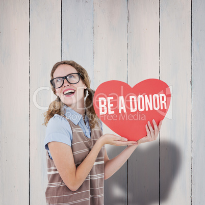 Composite image of geeky hipster woman holding heart card