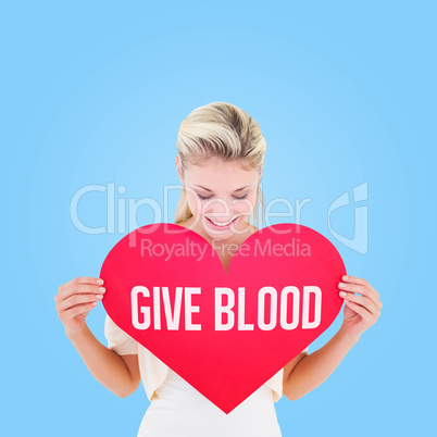 Composite image of attractive young blonde showing red heart