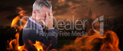 Composite image of businessman with headache