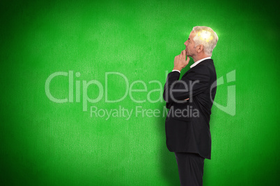 Composite image of thoughtful mature businessman posing