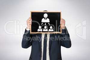 Composite image of businessman holding board