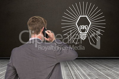 Composite image of back turned businessman on the phone