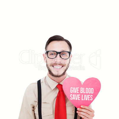 Composite image of geeky hipster smiling and holding heart card