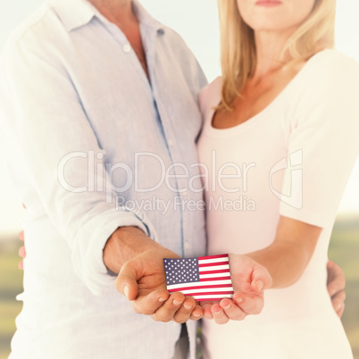 Composite image of happy couple holding their hands out