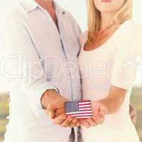 Composite image of happy couple holding their hands out