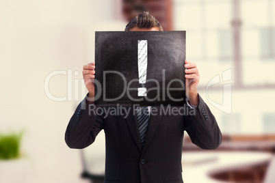 Composite image of businessman showing board