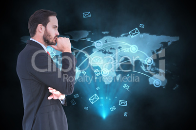 Composite image of thinking businessman standing with hand on ch