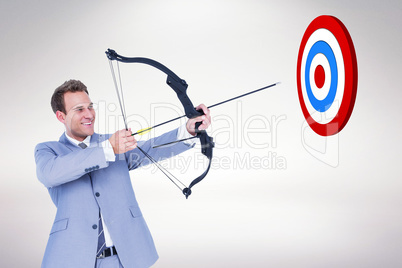 Composite image of businessman shooting arrow
