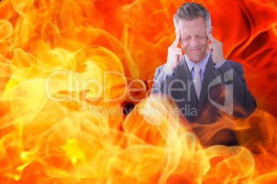 Composite image of businessman with headache