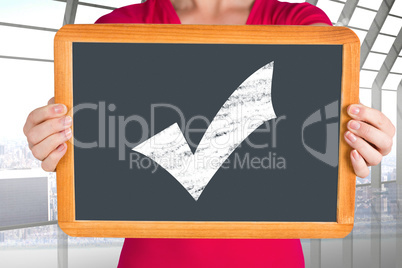 Composite image of woman showing chalkboard to camera