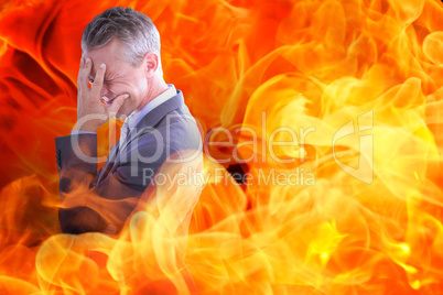 Composite image of businessman with headache