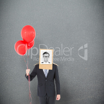 Composite image of businessman with photo box on head