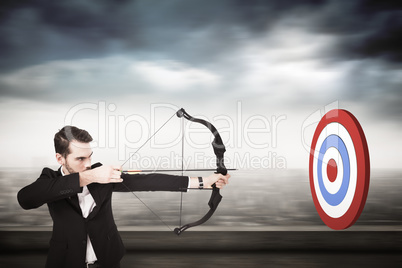 Composite image of elegant businessman shooting bow and arrow