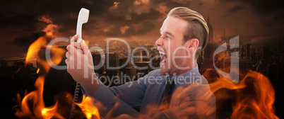 Composite image of businessman shouting at phone