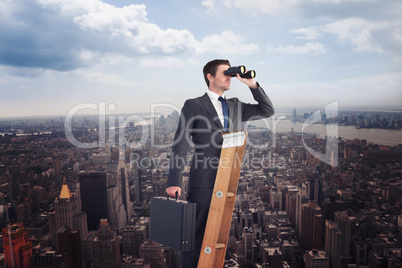 Composite image of businessman looking on a ladder