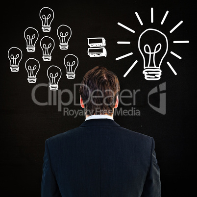 Composite image of rear view of businessman standing