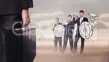 Composite image of businessman holding briefcase