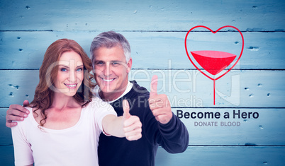 Composite image of casual couple showing thumbs up